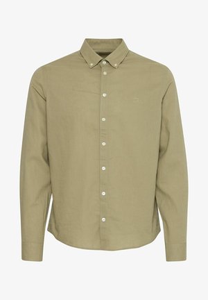 Gaiši zaļš, garām piedurknēm, pogājams krekls ar norādītu apkakli. Satur baltas pogas un smalku logotipu uz krūts. Strukturēta auduma.