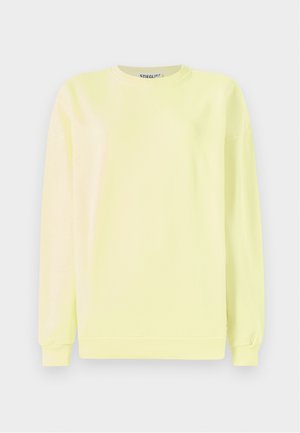 Light yellow sweatshirt made of cotton, featuring long sleeves, a round neck, and a ribbed hem. "STIEGLITZ" embossed on the front.