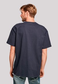 Dark navy short-sleeve t-shirt made from cotton with a ribbed texture. Features a relaxed fit and classic crew neckline.