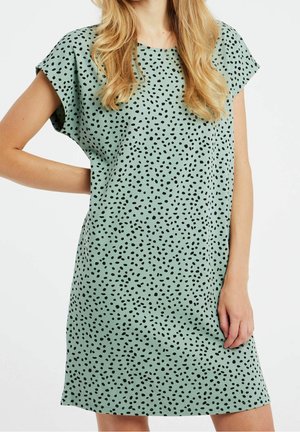 Mint green lyhythihainen mekko, jossa on mustia roiskepisteitä, rento istuvuus ja pehmeä kangas. Saavuttaa polven ylle ja siinä on pyöreä kaula-aukko.