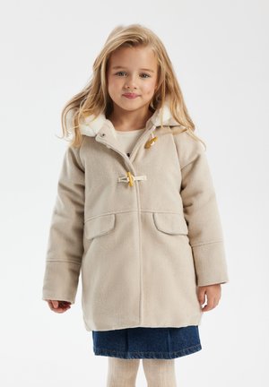 Beige fleecejacka med huva, med träspännen, två framfickor och en mjuk vit krage. Strukturerad, medellång design.