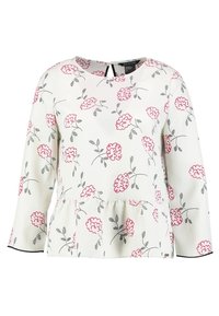 Top floreale bianco con fiori rosa e foglie grigie, maniche lunghe, design a peplo e dettagli a forma di chiave sulla schiena.