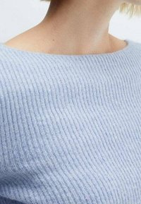 Lichtblauwe geribbelde trui met een brede halslijn, voorzien van een zachte textuur en subtiele horizontale lijnen. De stof oogt comfortabel en ademend.