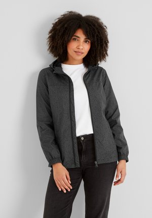 Lightweight waterproof jacket in dark gray with a subtle textured pattern, zip closure, and adjustable hood, paired with a white t-shirt and black pants.