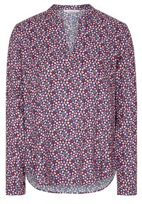 Blouse à manches longues en tissu léger, présentant un motif géométrique vibrant composé de formes roses, rouges, blanches et marine. Col Henley.