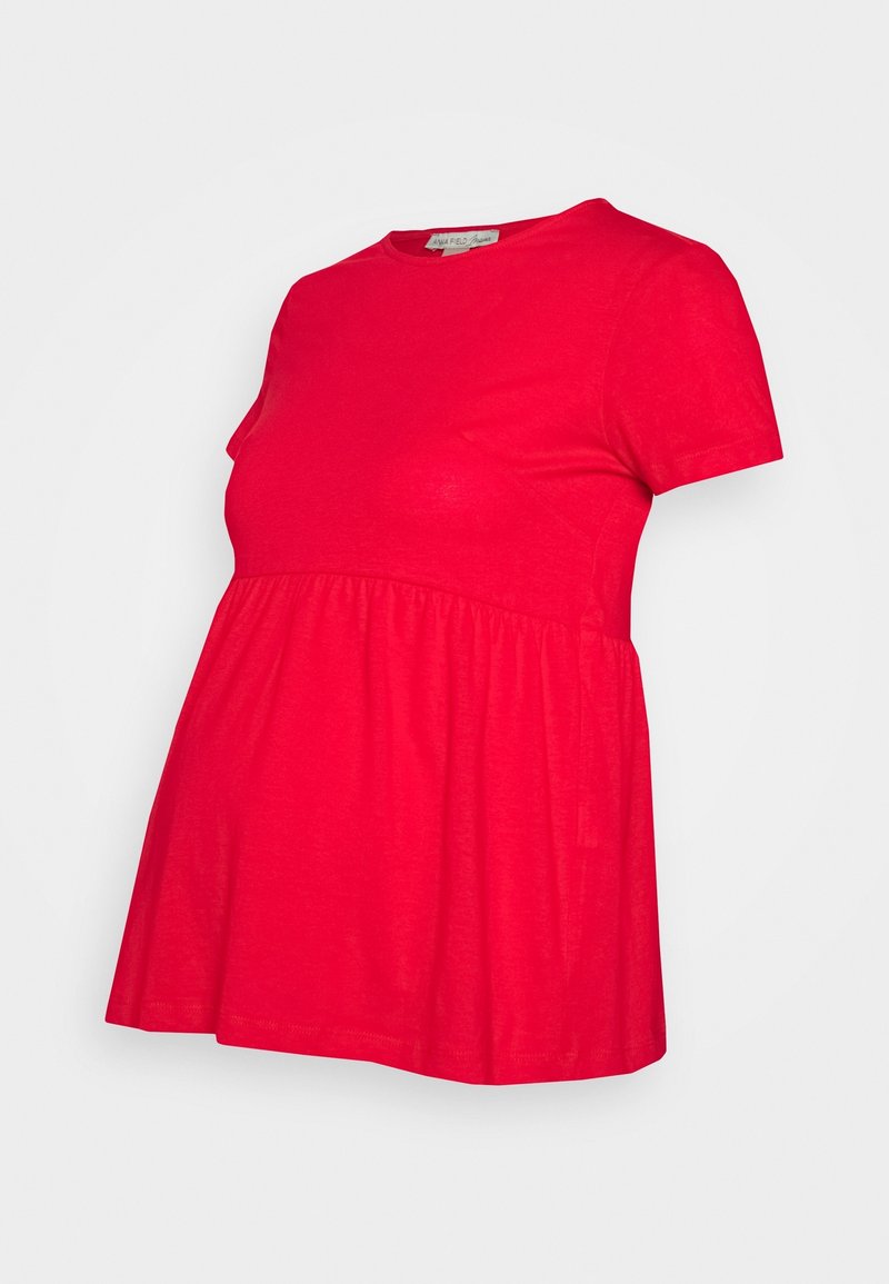 Haut de maternité rouge à manches courtes avec taille empire froncée et encolure ronde, présenté sur un fond blanc.