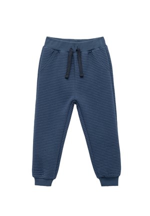 Marineblaue Jogginghosen aus geripptem Material. Ausgestattet mit einem elastischen Bund mit Kordelzug, Seitentaschen und schmal zulaufenden Bündchen.