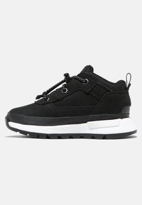 Black athletic shoes with a textured upper, contrasting white midsole, and black rubber outsole. Features integrated laces for fit adjustment.