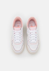 White athletic sneakers with pink accents, featuring smooth leather, perforated detailing, and a cushioned sole. Laces are central.