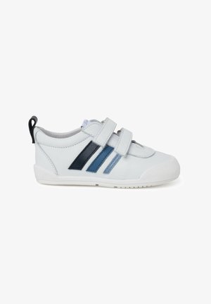 White sneaker with two hook-and-loop straps, featuring blue and navy stripes on the side, and a textured rubber sole.