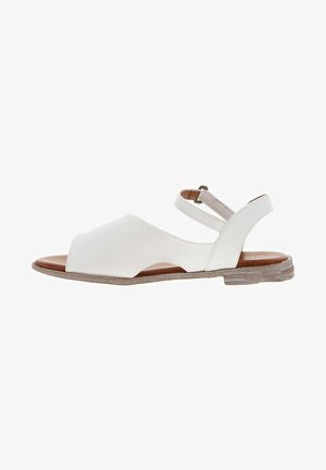 White leather sandal with an open toe design, adjustable ankle strap, and a textured light brown sole. Features a smooth finish.