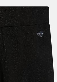 Guess JUNIOR PUNTO MILANO FLARE - Trousers - jet black a996