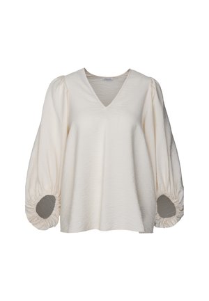 Cremefarvet bluse med V-hals, afslappet pasform og voluminøse puffærmer med indsamlede manchetter og cirkulære udskæringer. Struktureret stof.