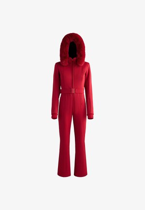 Red jumpsuit with a faux fur-lined hood, long sleeves, and a belted waist. It features textured panels and a flared leg design.