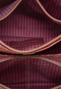 Zippered pouch with a floral exterior pattern, smooth fabric, and a burgundy striped interior. Features a label reading "Pip Studio."