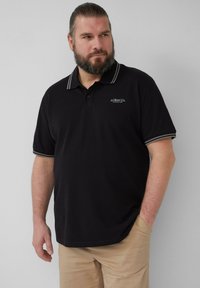 Zwarte polo met een grijs gestreepte kraag en manchetten, voorzien van een logo op de borst, gemaakt van gladde stof en casual snit.