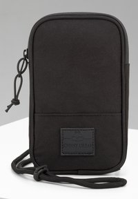 Black fabric pouch with a rectangular shape, zipper closure, and a front patch featuring the brand name "JOHNNY URBAN." Textured surface.