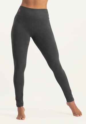 Leggings gris en matériau doux, avec une taille haute et un design lisse et ajusté. Sans motifs ni accessoires visibles.