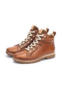 Brown leather high-top boots with textured fabric accents, cream laces, rubber outsole, and embossed logo on the tongue.