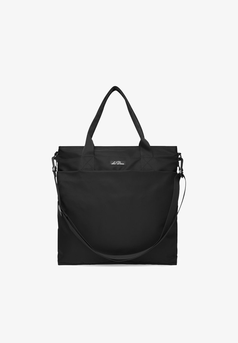 Black tote bag made of durable fabric, featuring dual top handles and an adjustable shoulder strap, with a minimalist design.