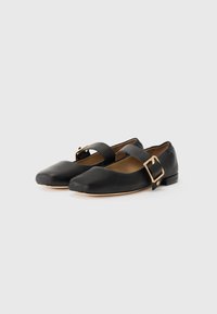 Black leather Mary Jane flats featuring a rounded toe, ankle strap with a gold buckle, and a low, square heel. Smooth texture throughout.