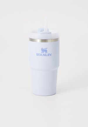 Light blue insulated tumbler with a smooth finish, silver metal band, and a white lid featuring a straw opening, branded with "STANLEY."