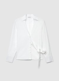 White long-sleeve blouse with a collared neckline, front button closure, and tied bow detail on the side for adjustable fit. Smooth texture.