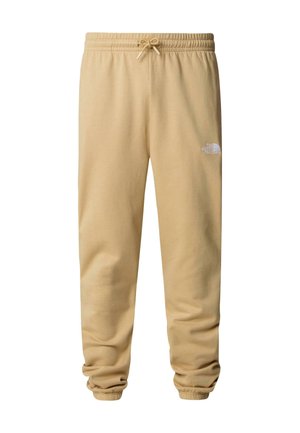 Pantaloni sportivi beige realizzati in tessuto morbido, con cintura elastica e cordino, orli con polsini e un piccolo logo bianco sulla coscia.