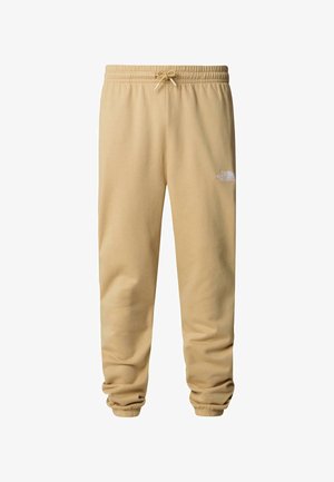 Pantaloni sportivi beige realizzati in tessuto morbido, con cintura elastica e cordino, orli con polsini e un piccolo logo bianco sulla coscia.