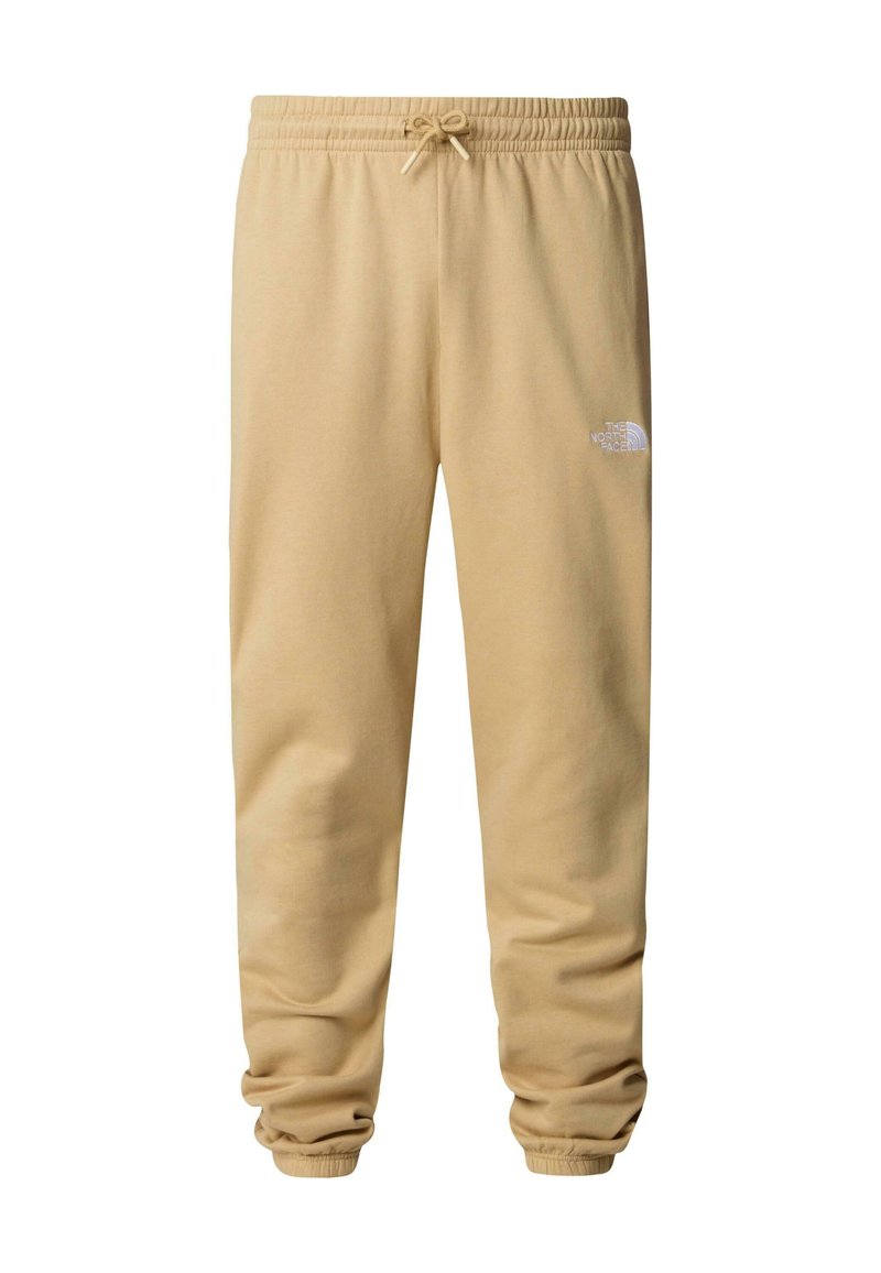 Pantalons de survêtement beiges en tissu doux, avec une taille élastique à cordon de serrage, des chevilles resserrées et un petit logo blanc sur la cuisse.