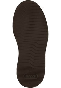 Dunkelbraune Gummisohle mit ausgeprägten horizontalen und vertikalen Rillen. Verfügt über ein kreisförmiges Logo und die Größenangabe "37" in der Nähe der Ferse.
