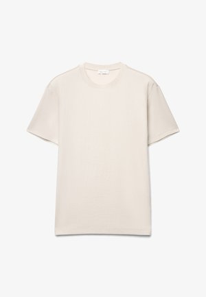 T-shirt à manches courtes, côtelé, beige crème, à col rond, présenté à plat sur fond blanc.