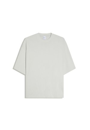 T-shirt oversize gris clair à manches courtes et col rond, posé à plat sur fond blanc.