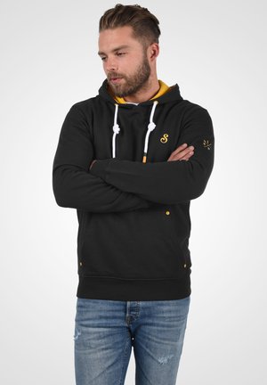Black hoodie with yellow accents, white drawstrings, and a front pocket. Features an embroidered logo on the chest and right sleeve.