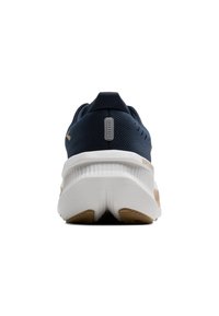 Navy athletic shoes featuring a textured upper, cushioned white midsole, and a rubber outsole with light brown accents.
