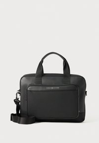 Black laptop bag with a smooth finish, dual top handles, adjustable strap, front zip pocket, and a silver logo detail. Textured accents visible.