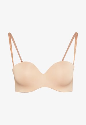 Underwire bra in soft beige fabric. Contoured cups with adjustable light brown straps featuring logo accents. Smooth, seamless design.