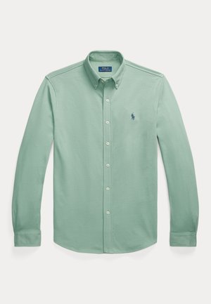 Light green long-sleeve button-up shirt made of soft fabric, featuring a pointed collar, button closure, and small embroidered logo on the chest.