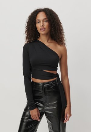 Black one-shoulder top with long sleeve and wrap-around design. Smooth, stretchy fabric. Paired with high-waisted, glossy black pants.