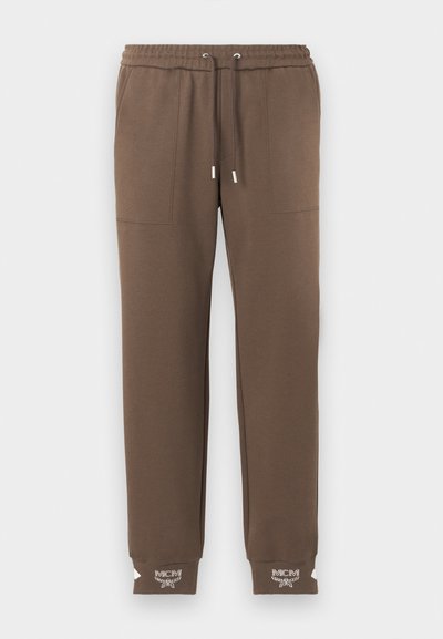 Bruine taps toelopende sweatpants met elastische tailleband, koord, voorzakken en wit MCM-logo op geribde enkelmanchetten.