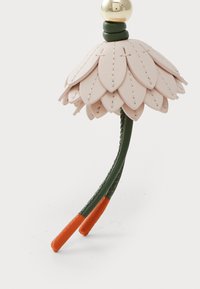 Leather flower accessory with pink petal layers, green stem, orange tips, and a gold bead at the top. Features stitched details.