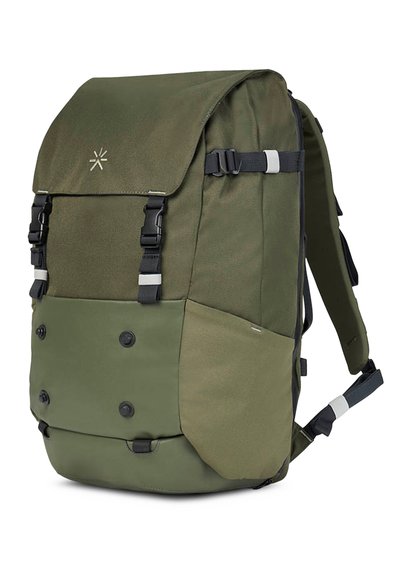 Mochila verde oliva con solapa frontal y doble hebilla, que presenta un material texturizado, múltiples bolsillos y correas ajustables.