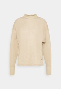 Kardigan s dlouhými rukávy v béžové barvě, vyrobený z texturované, třpytivé látky a s vysokým, volánkovým límcem. Manžety mají rovněž texturu s jemným leskem.