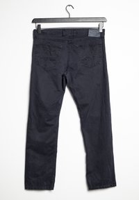 Mörkblå bomullsjeans med rak passform, hängande på en svart galge. Har två sexkantiga bakfickor med dekorativ sömnad.