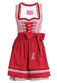 Robe dirndl en vichy rouge avec une doublure intérieure blanche. Présente un bord en dentelle, des boutons décoratifs et un nœud à la taille. Détail de broderie en forme de cœur.