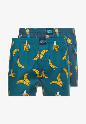 Tropfenfarbene Badeshorts mit gelben Cartoon-Bananen und Ananas. Glattes Material mit elastischem Bund. Zwei Paar enthalten.