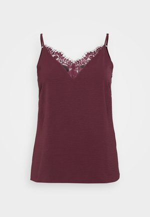 Burgundy camisole with adjustable straps, featuring a lace V-neck trim. Soft texture with a relaxed fit and hemline that sits below the waist.