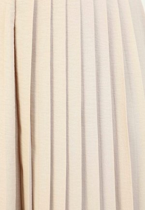 Pleated fabric skirt in light beige, made from a soft textile. Features vertical folds with a subtle textured surface.