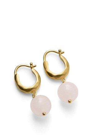 Gold hoop earrings with irregular shapes, each featuring a smooth, round pale pink stone dangling below.
