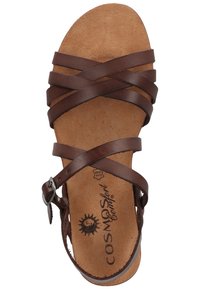 Sandalo in pelle marrone con fasce incrociate, fibbia regolabile e soletta in sughero imbottita. La suola è piatta per garantire comfort.